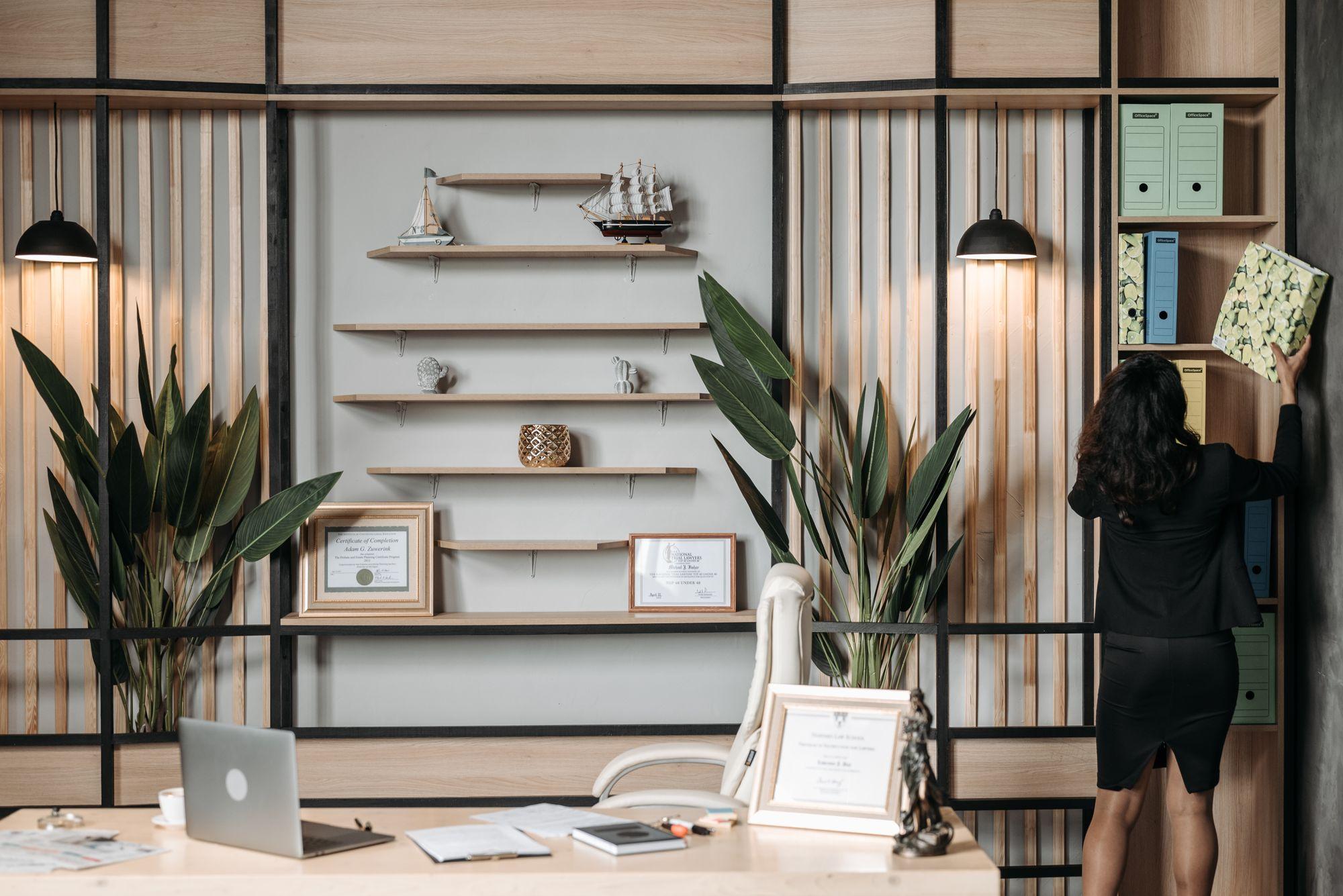 Property manager filing condo corporation records in labelled binders on an office shelf, ready for an owner's section 55 records request