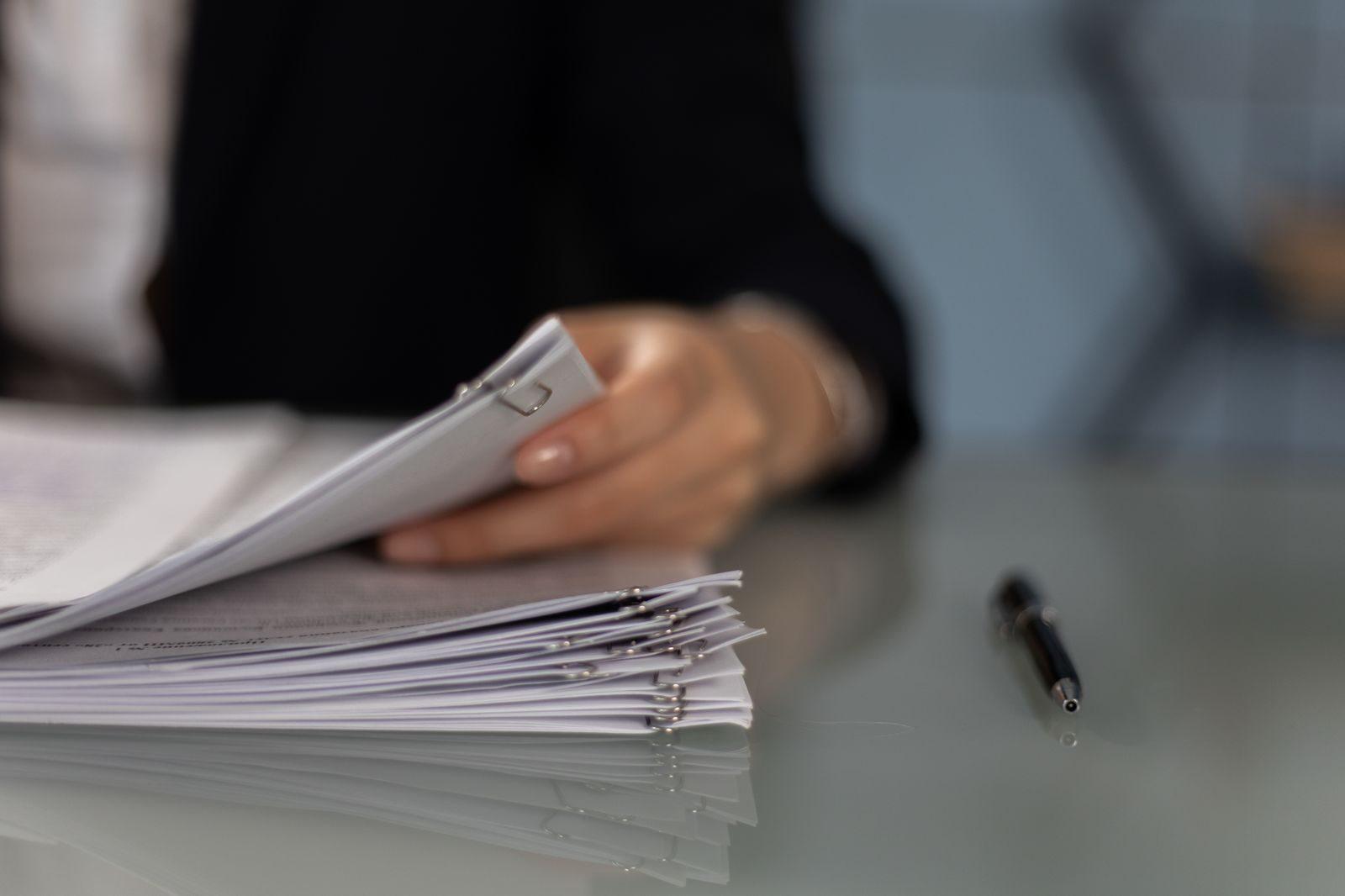 Hand holding condo insurance policy paperwork while reviewing a deductible chargeback