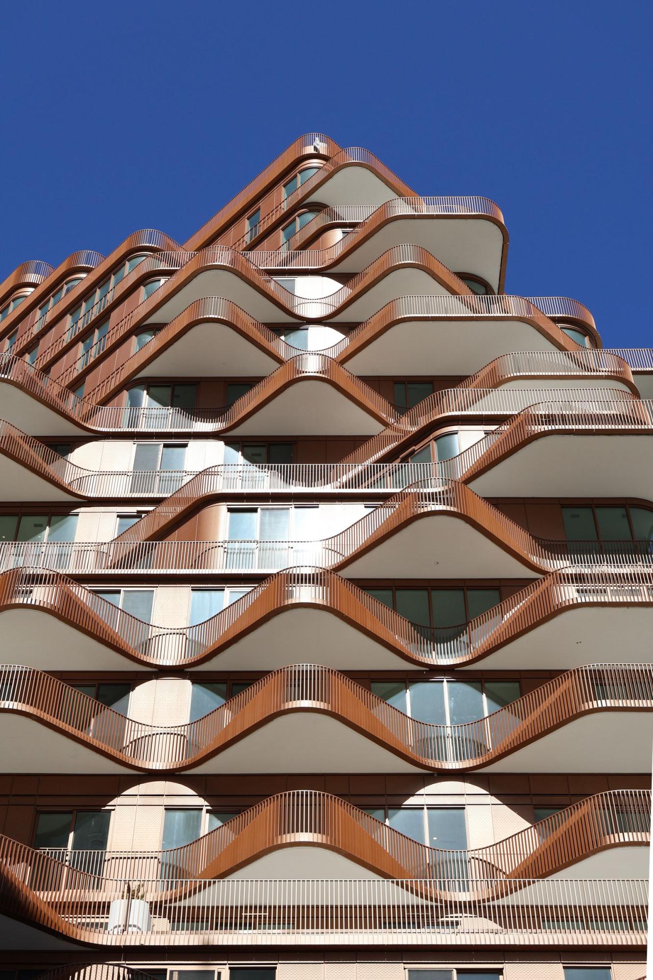 Modern Toronto condominium tower with wave-shaped balconies, illustrating the shared and exclusive-use spaces governed by a condo's declaration, by-laws and rules